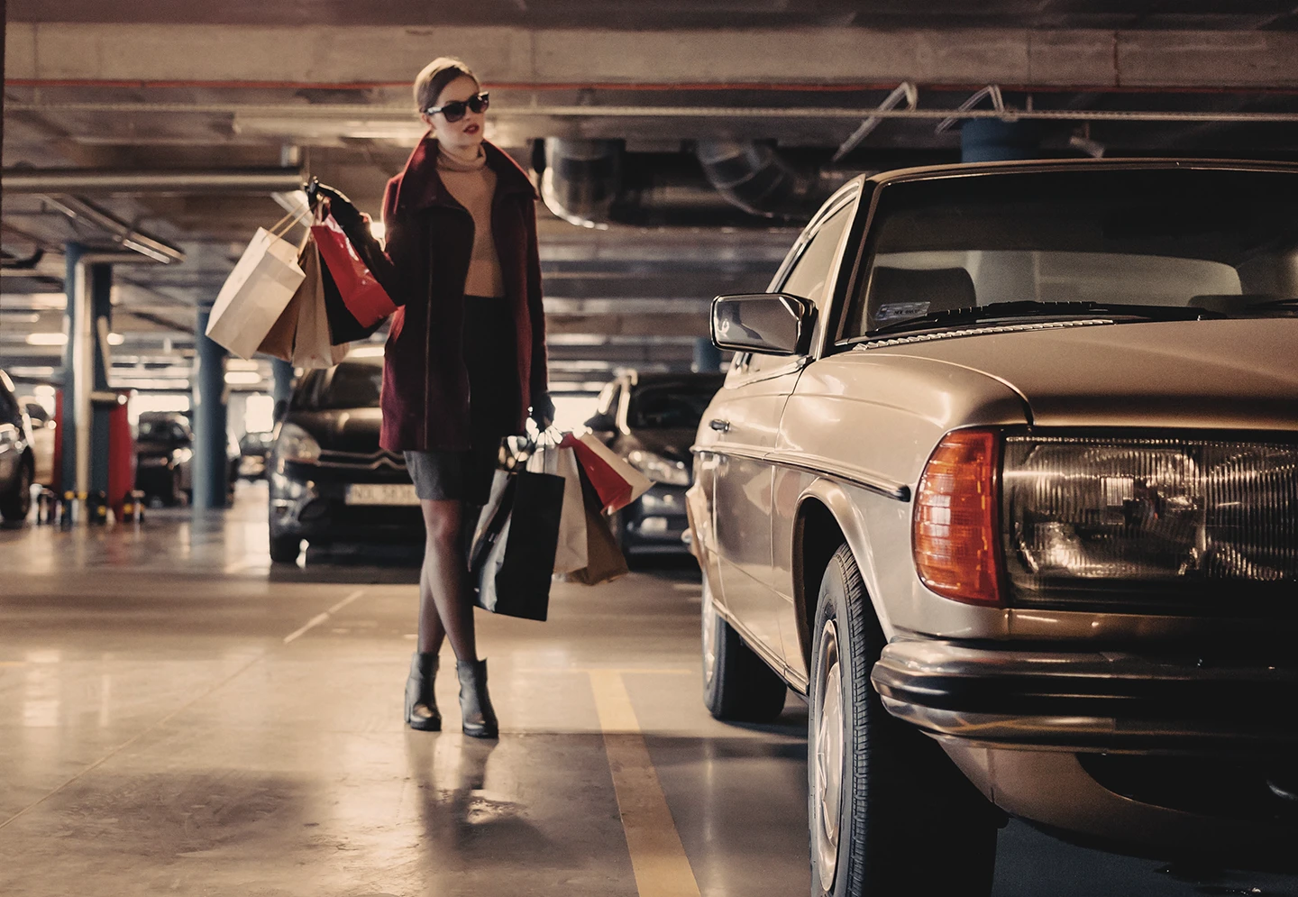 Woman with shopping bags by her car